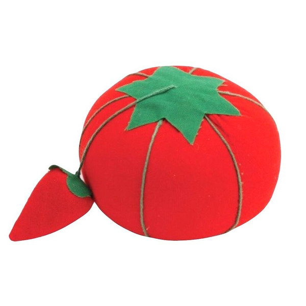 A red pin cushion in the shape of a tomato, attached to it is a small strawberry shaped pad filled with emery sand for keeping pins and needles sharp.
