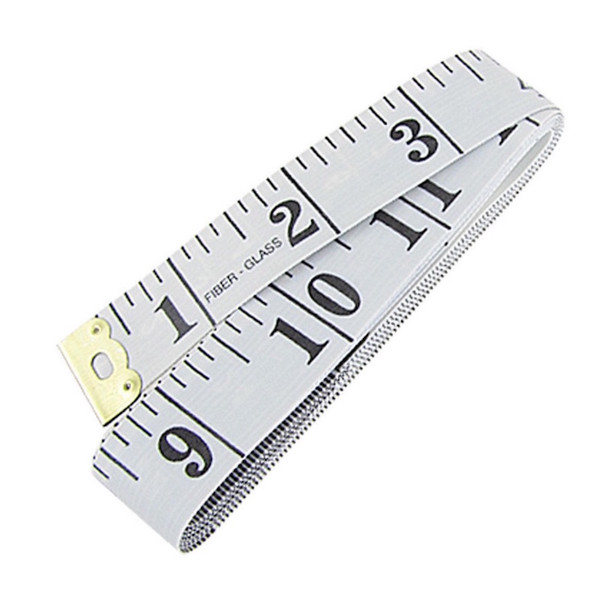 Image shows a white flexible tailoring tape measure marked with both centimetres and inches. The tape is coiled, showing clear black measurement markings on a white fibreglass background.