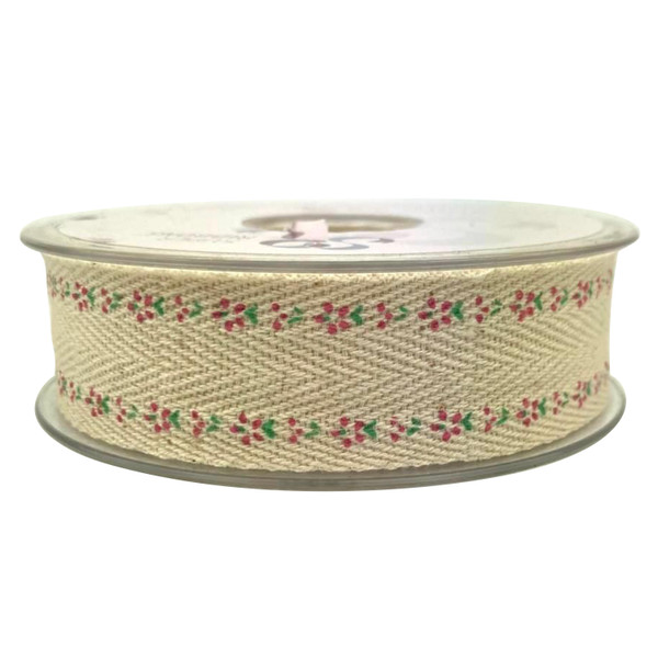 A spool of cream coloured woven ribbon tape with a printed pattern of mini pink flowers and green foliage.