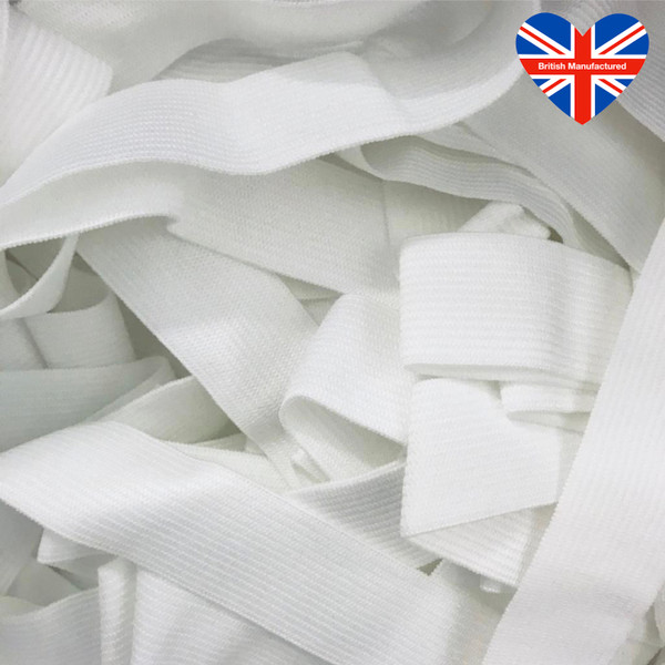 Close-up of white 25mm soft elastic ribbon with a British Manufactured heart logo in the corner.