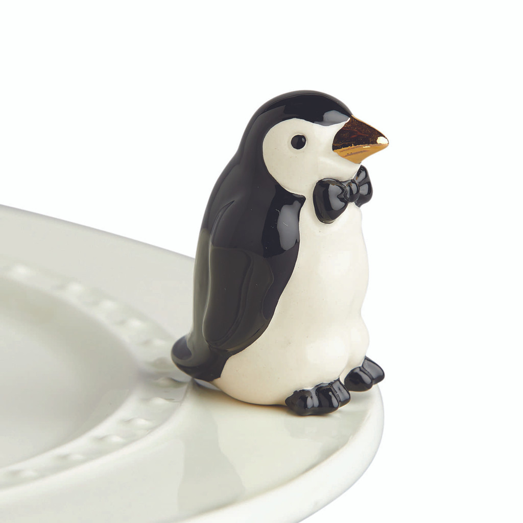 Nora Fleming Tiny Tuxedo A237
Our little penguin mini features a gold beak and is just chillin’ with his tiny bow tie, too!
not dishwasher safe; hand wash only