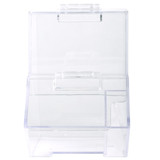 A clear plastic dispenser with a hinged lid and a scoop compartment on the side. It features a simple, transparent design.