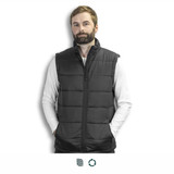 A man in a black puffer vest stands against a plain background, wearing a long-sleeve white shirt underneath. A man in a black puffer vest stands against a plain background, wearing a long-sleeve white shirt underneath.