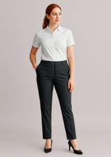 A pair of women's bandless elastic waist pants in dark grey, styled with a white shirt and black heels.