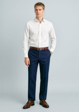 A model wearing navy flat front slacks paired with a white shirt and brown belt, set against a light background.