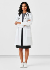 A unisex classic lab coat in white, worn by a person standing with arms crossed, featuring pockets and a stethoscope.