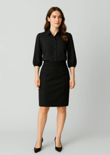A black mid-waist pencil skirt paired with a matching black blouse, featuring a logo on the garment.