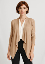 A beige women's waterfall cardigan with an open front and long sleeves, worn over a white top and black trousers.