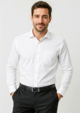 A white long sleeve button-up shirt with a chest pocket, worn by a man. The shirt features a classic fit design.