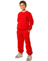 A child wearing a red crew neck fleecy sweater and matching pants, paired with sporty shoes.