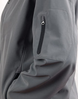 A grey softshell jacket featuring a zippered pocket on the sleeve and a sleek design.