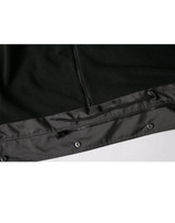 A black Long Line Stadium Jacket featuring a zippered pocket and snap fasteners at the hem. It has branding elements.