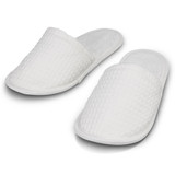White waffle slippers with a textured surface and soft interior, featuring a simple design without visible branding.