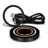 A black wireless charger with circular design and a USB charging cable in a coiled arrangement. A black wireless charger with circular design and a USB charging cable in a coiled arrangement.