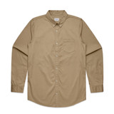 A beige button-up shirt with long sleeves and a single chest pocket. It features a classic collar and a brand logo.