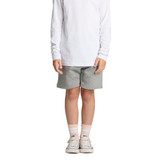 Grey sports shorts for kids, paired with a long white top and light-coloured shoes, featuring a logo.