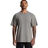 A heavy faded tee in a grey colour, featuring a loose fit and short sleeves, displayed on a model with tattoos.