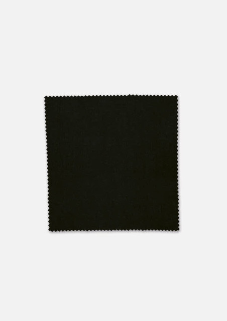 A square piece of black fabric with a scalloped edge, displaying a smooth texture.