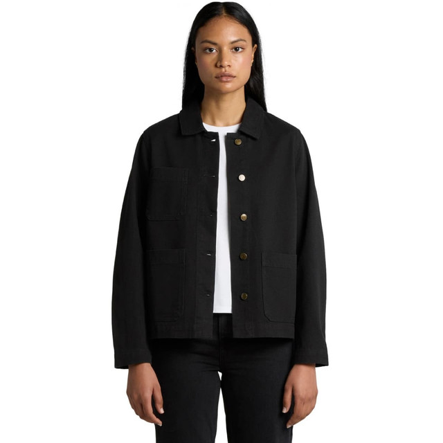A black canvas chore jacket with button closure and front pockets, modelled by a person wearing a white top.