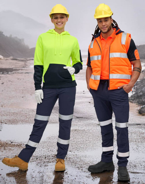 A woman in a high-vis yellow and navy hoodie and a man in an orange vest wear navy pants with reflective tapes.