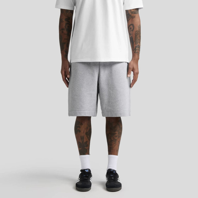 Grey shorts with an elasticated waist, paired with a white t-shirt, worn by a person with visible tattoos.