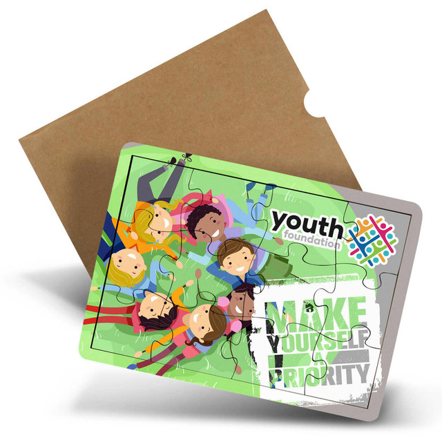 A wooden puzzle with 12 colourful pieces featuring illustrated children and a logo. Comes in a cardboard packaging. A wooden puzzle with 12 colourful pieces featuring illustrated children and a logo. Comes in a cardboard packaging.