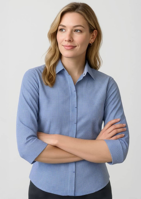 A blue women's button-up shirt with 3/4 sleeves and a fitted design. It has a subtle pattern and a logo.