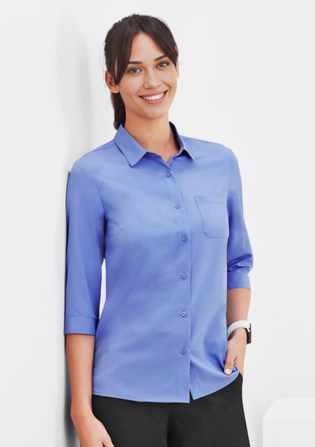 A blue women's button-up shirt with 3/4 sleeves and a chest pocket, displayed on a model.