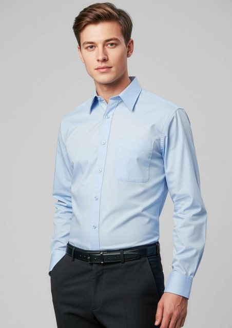 A light blue long sleeve button-up shirt with a single chest pocket, worn by a model. The shirt features a branding logo.