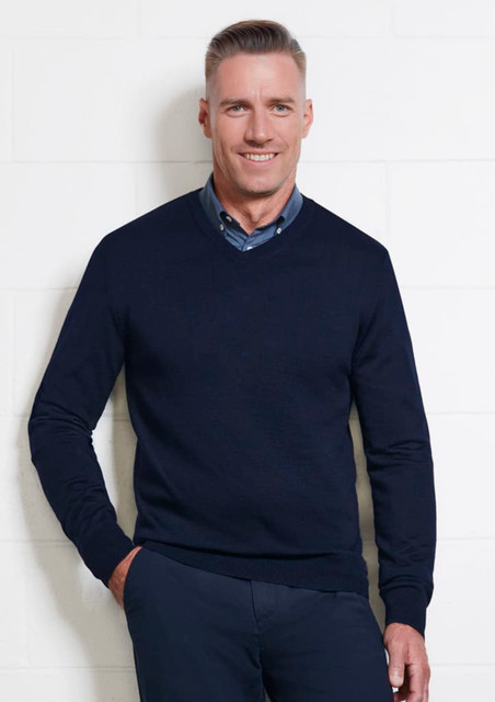 A navy men's knitted pullover with a V-neck, modelled by a smiling man against a white wall. A navy men's knitted pullover with a V-neck, modelled by a smiling man against a white wall.