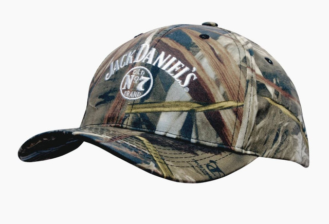 A camouflage cap featuring a full brim and a logo, predominantly in earthy tones of green, brown, and tan. A camouflage cap featuring a full brim and a logo, predominantly in earthy tones of green, brown, and tan.