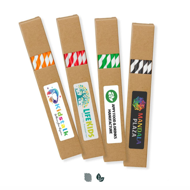 Four sets of paper drinking straws in various colours, each packaged in a kraft paper sleeve featuring branding.