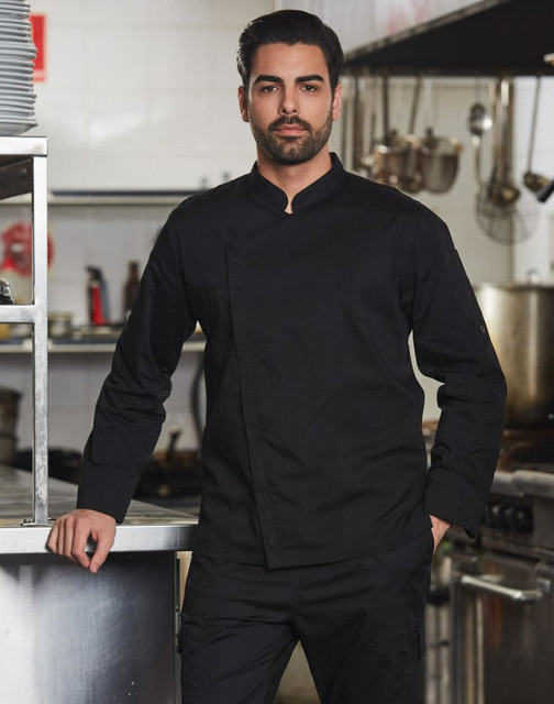 A black men's functional chef jacket, featuring a sleek design and a prominent logo, displayed in a kitchen setting.