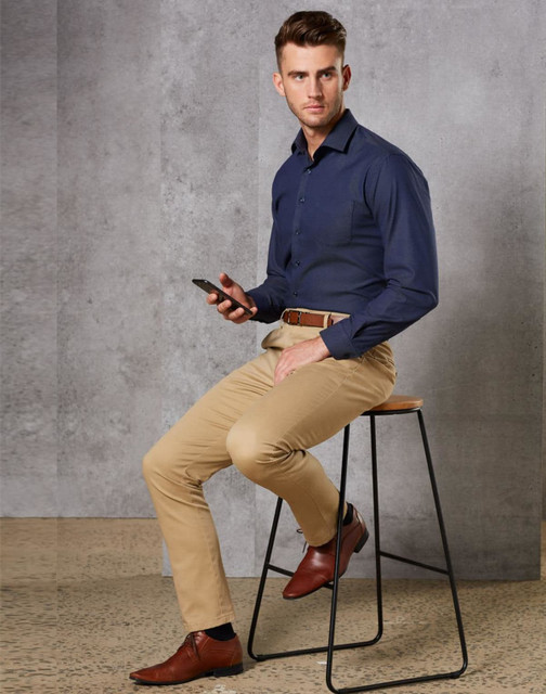 Men's Boston Chino Pants in beige, paired with a navy shirt and brown shoes, displayed on a stool. Men's Boston Chino Pants in beige, paired with a navy shirt and brown shoes, displayed on a stool.