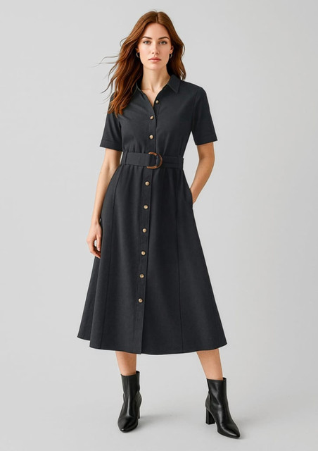 A black midi dress with short sleeves, button detailing, a belted waist, and styled with black ankle boots.