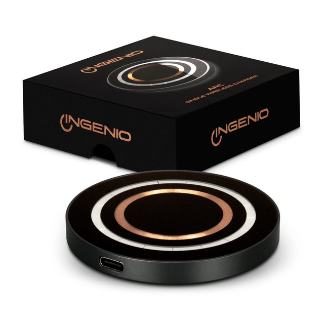 A wireless charger in black, featuring a circular design with metallic accents, alongside its packaging. A wireless charger in black, featuring a circular design with metallic accents, alongside its packaging.