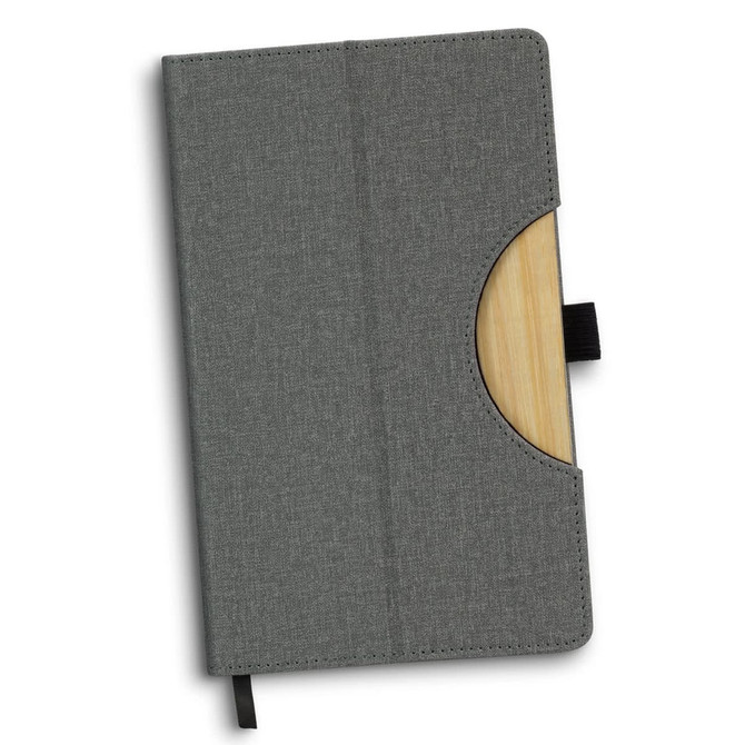 A grey notebook with a wooden accent and a pocket for cards, featuring a ribbon bookmark and a logo.