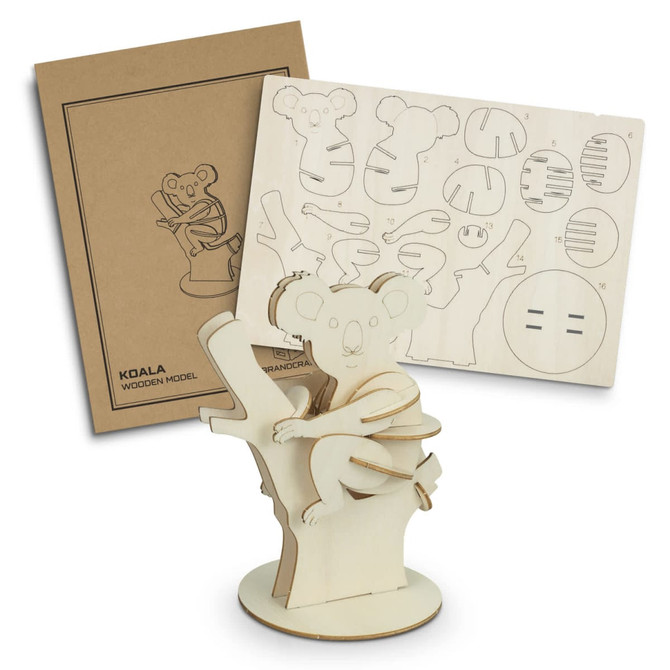 A wooden model of a koala clinging to a tree, accompanied by a cut-out sheet and packaging. Natural wood colour.