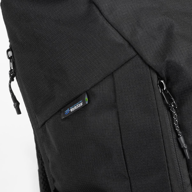 A black roll-up computer backpack featuring detailing and a logo on the side. Zippers are visible for secure closure.