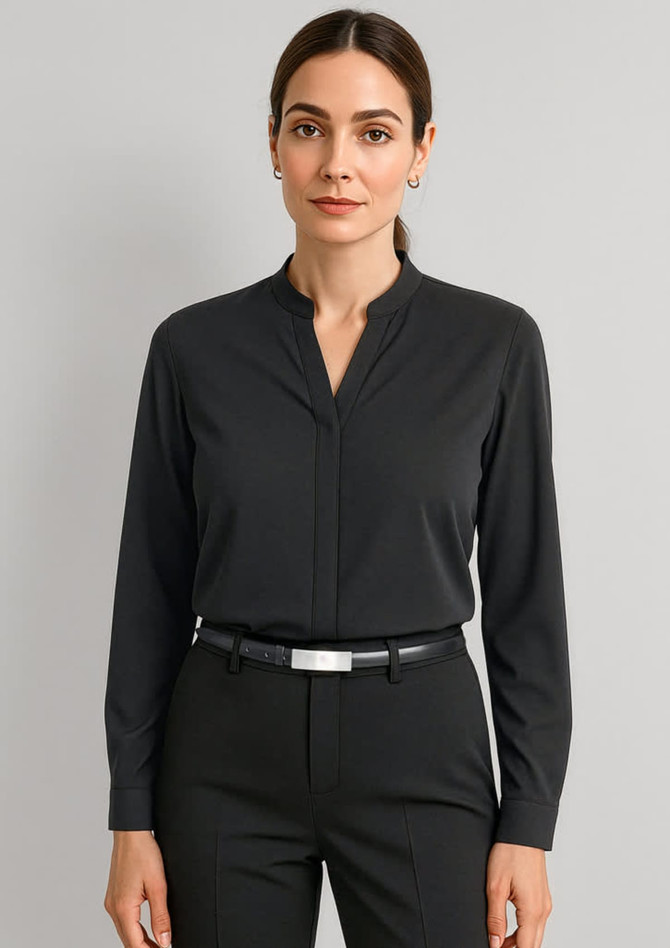 A black long sleeve blouse with a collar and button detail, paired with a black belt and trousers.
