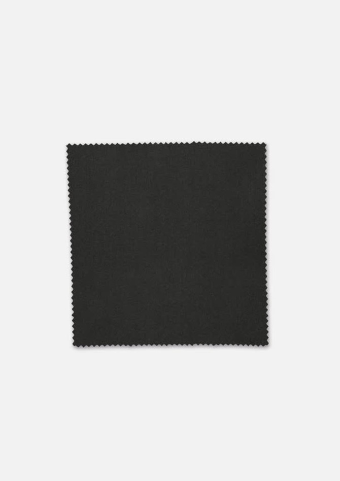 A piece of dark green fabric with a smooth texture and scalloped edges, featuring a subtle sheen.