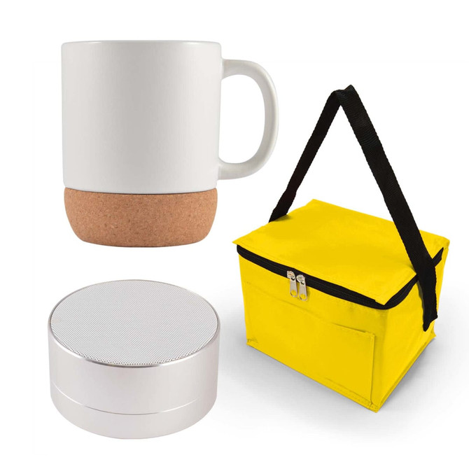 An espresso coffee cup with a cork base, a compact silver speaker, and a yellow insulated carrying bag.
