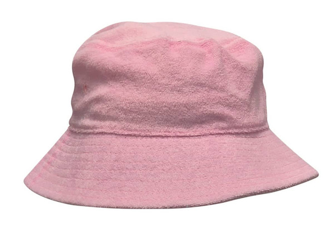 A pink terry towelling bucket hat with a wide brim and soft texture, featuring a logo.