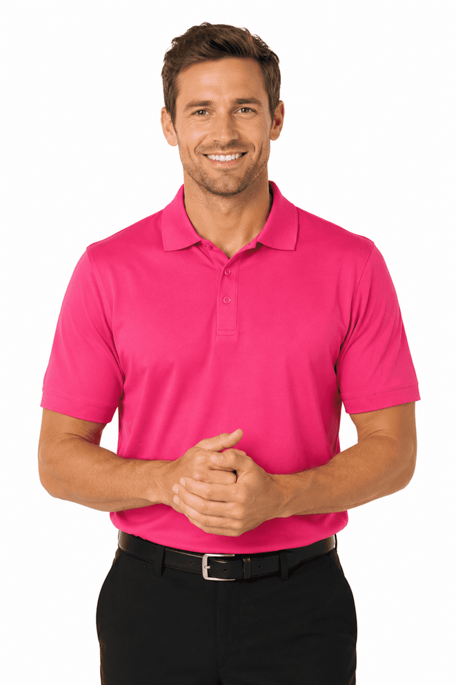 A man wearing a vibrant pink polo shirt, smiling with hands clasped, paired with black trousers. The shirt features a logo.