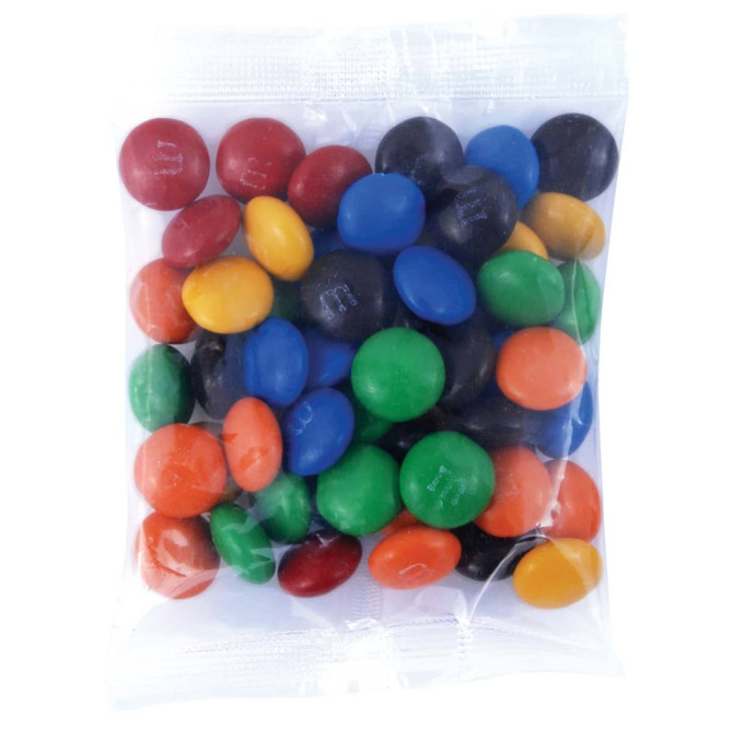 A clear bag filled with a variety of colorful M&M's, including red, blue, green, yellow, orange, and black candies.