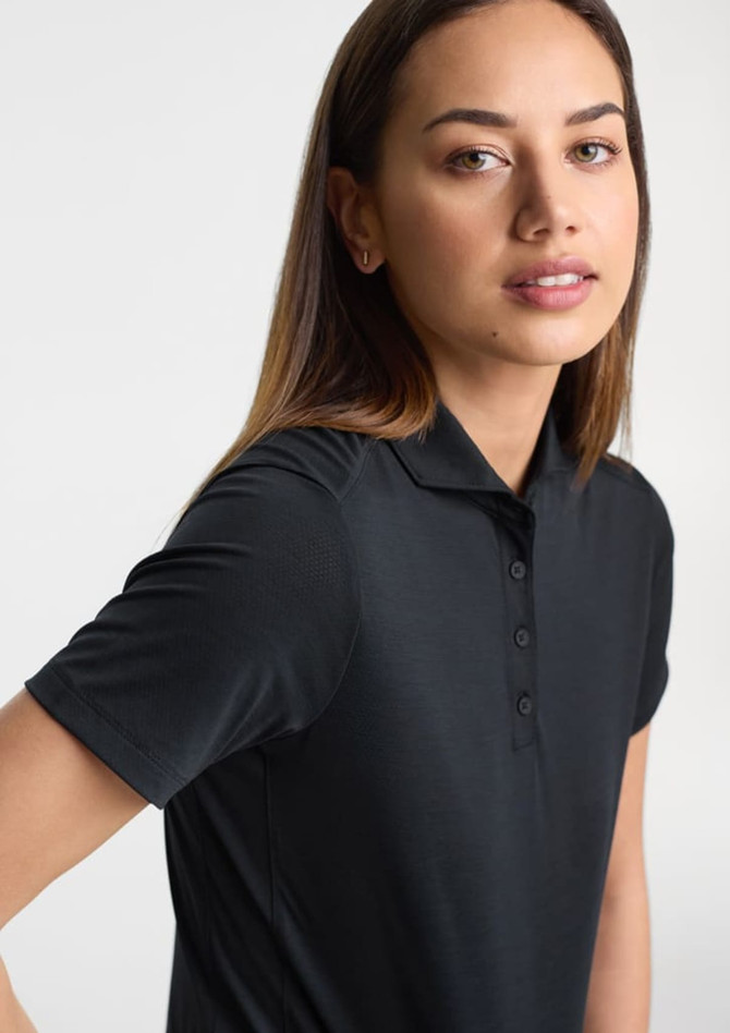 A women's short sleeve polo in black with a collared neckline and buttons, featuring a logo on the chest.