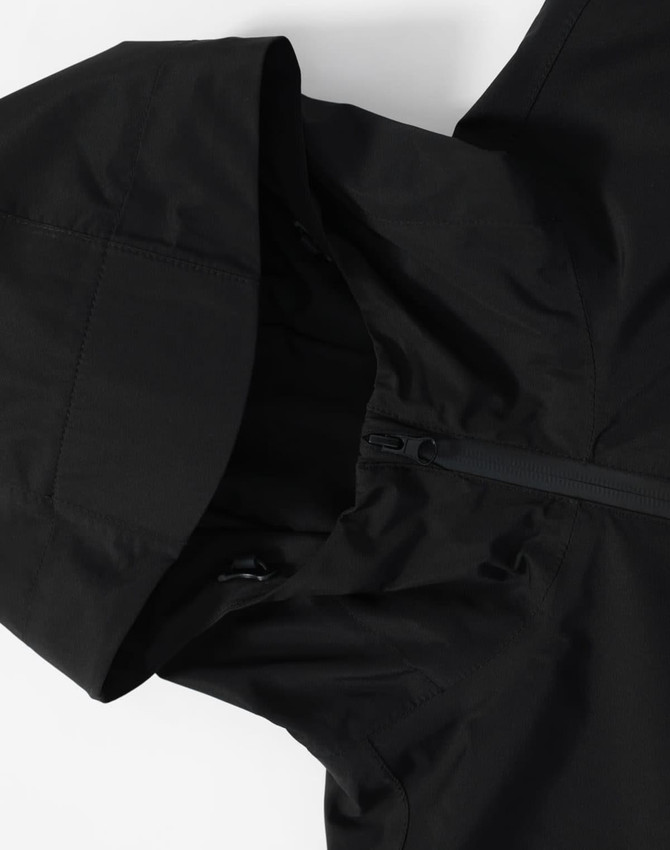 A black unisex waterproof jacket featuring a hood and zip closure, with a logo on the fabric.