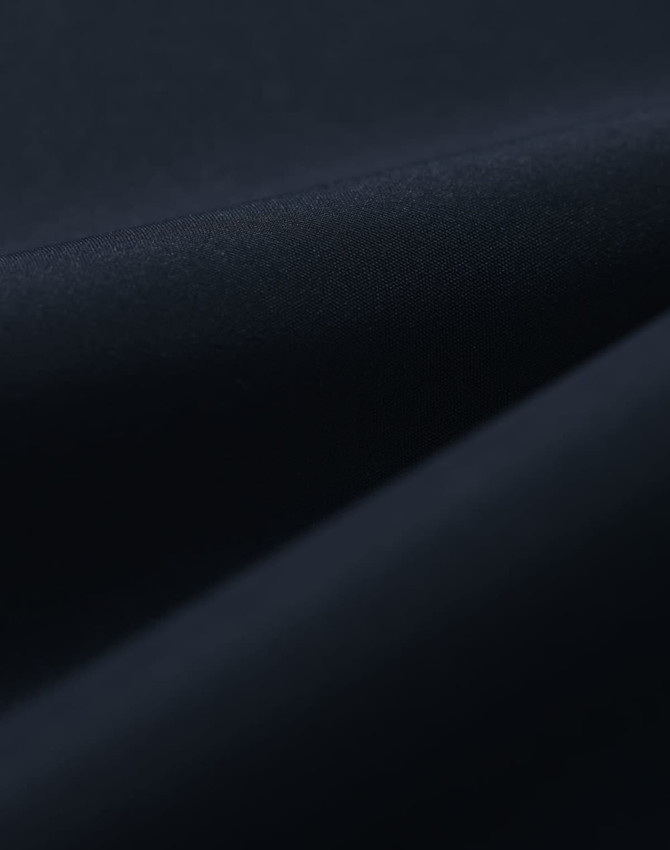 A close-up of a dark navy fabric, featuring a smooth texture suitable for a waterproof jacket.