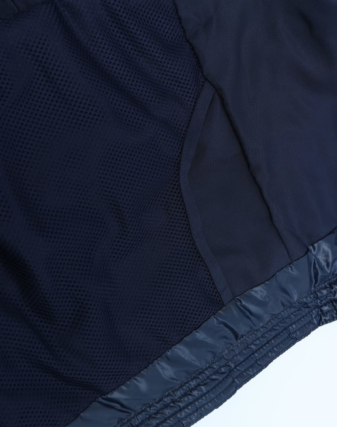 A navy hooded puffer jacket featuring a lightweight design and mesh detailing on the interior lining.
