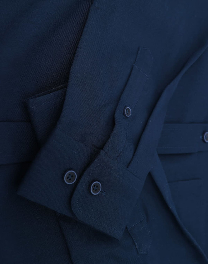 A navy cotton blend long-sleeve shirt with buttoned cuff details and a sleek collar. Features a logo.